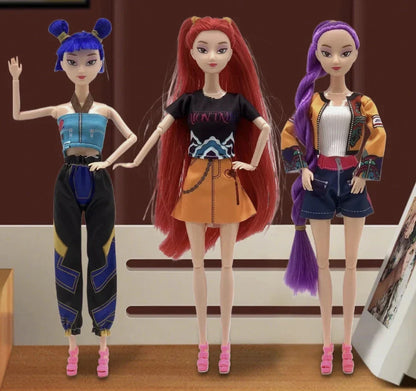 Three dolls with colorful hairstyles and outfits standing against a brown background.